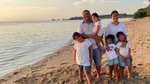 Lemuel on the beach with wife and four daughters