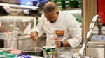 A chef from Unilever Food Solutions sprinkling some Knorr product into a tray