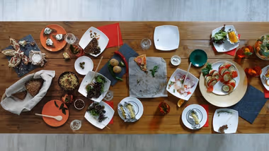 After party. Wasted food laid out on festive wooden table.