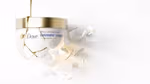 A jar of Dove’s premium Intensive Care hair repair mask, shattered and mended with molten gold in a Kintsugi style.
